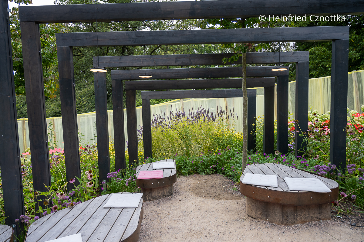 Hölzerne Tore überspannen den Sitzplatz im Garten Tore aus dunklem Holz
überspannen den Sitzplatz im Garten