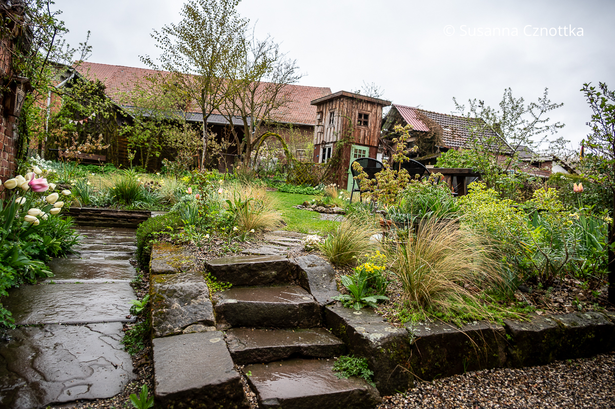 Blick in den Garten mit einem Spielhaus für Kinder