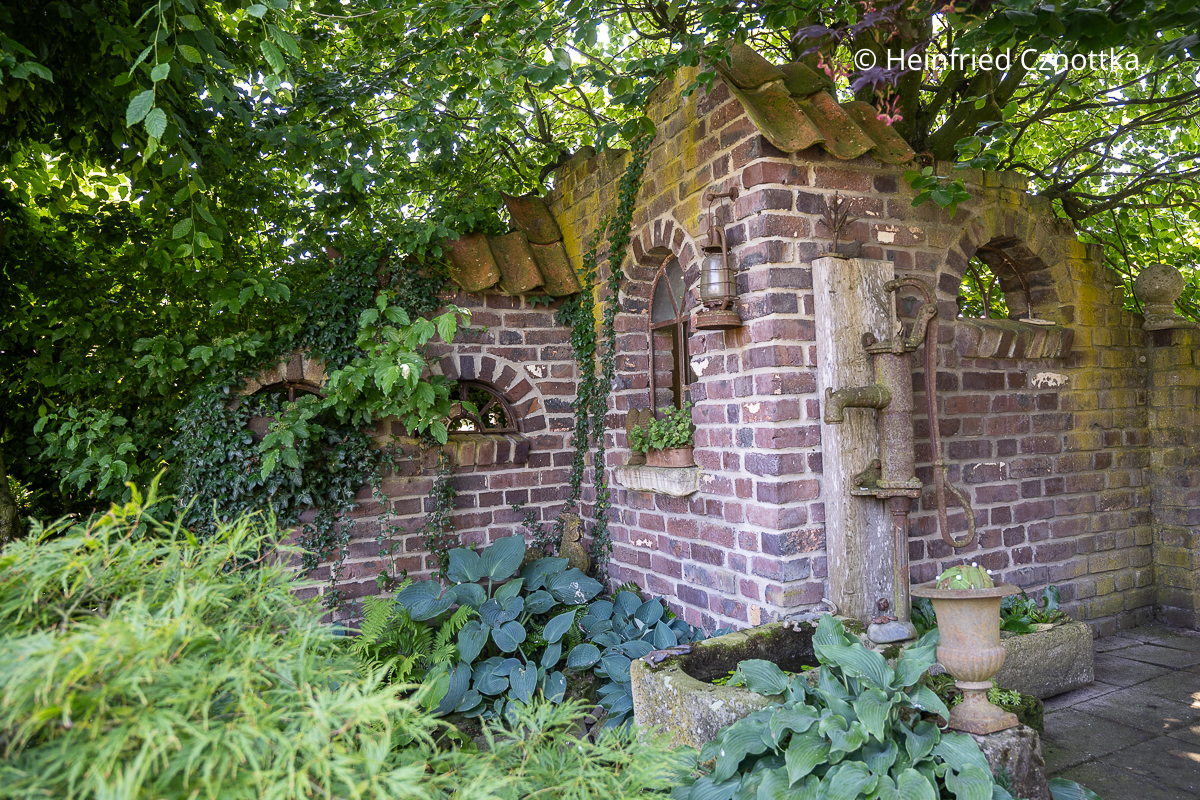 Ausgefallene Gartenidee: eine aus Klinker gemauerte "Ruine" mit mehreren halbrunden Fenstern Ausgefallene Gartenidee: eine aus Klinker gemauerte "Ruine" mit mehreren halbrunden Fenstern